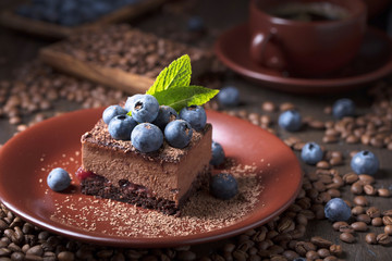Chocolate cake with blueberries and mint .