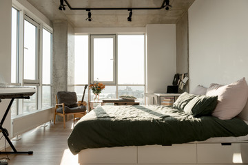 close up view of empty modern room interior with big window and bed