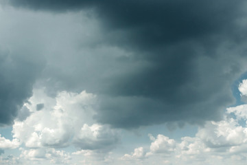 Obraz premium Fantastic, fluffy, white clouds against a blue sky. Rain clouds. The situation in the sky before the storm. copy space
