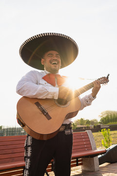 Mexican musicians mariachi playing the guitar