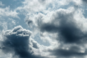 Fantastic, fluffy, white clouds against a blue sky. Rain clouds. The situation in the sky before the storm. copy space