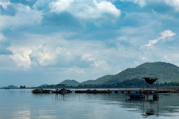 Floating raft made of steel and plastic bucket With boat engines in Krasiew dam ,Supanburi Thailand.