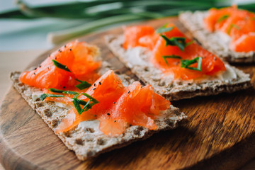 Salmon toast on a wooden background