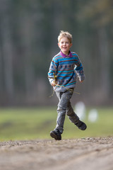 Fototapeta premium Boy running with branch