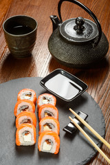 Cast-iron teapot and sushi