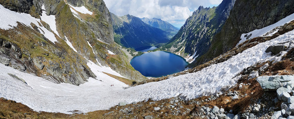 Morskie Oko. High Tatras, Poland, May 27, 2018. Beautiful landscape of snowy mountain tops and the lake between them. © volff