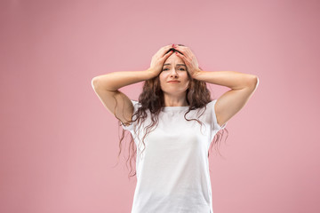 Fototapeta premium Woman having headache. Isolated on pink background. Businesswoman standing with pain isolated on trendy studio background. Female half-length portrait. Human emotions, facial expression concept. Front
