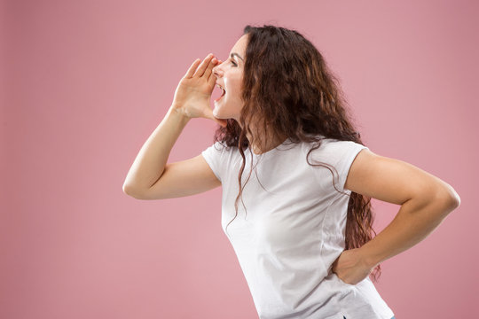 Do Not Miss. Young Casual Woman Shouting. Shout. Crying Emotional Woman Screaming On Pink Studio Background. Female Half-length Profile Portrait. Human Emotions, Facial Expression Concept. Trendy