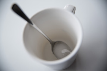 A white cup with a spoon is a top view. Белая чашка с ложкой вид сверху.