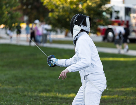 Fencing athlete in attacking position