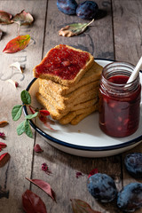 healthy breakfast: stack of rusks with homemade plum and hazelnuts jam. Selective focus 