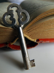 A key and an open old book