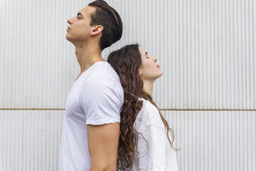 Portrait of a young man and a young woman back to back
