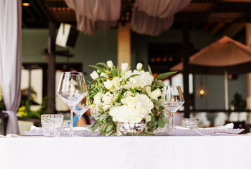 Set table for a white and aqua blue wedding dinner decorated