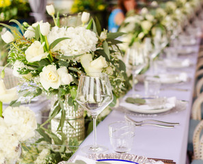 Set table for a white and aqua blue wedding dinner decorated