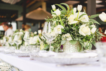 Set table for a white and aqua blue wedding dinner decorated