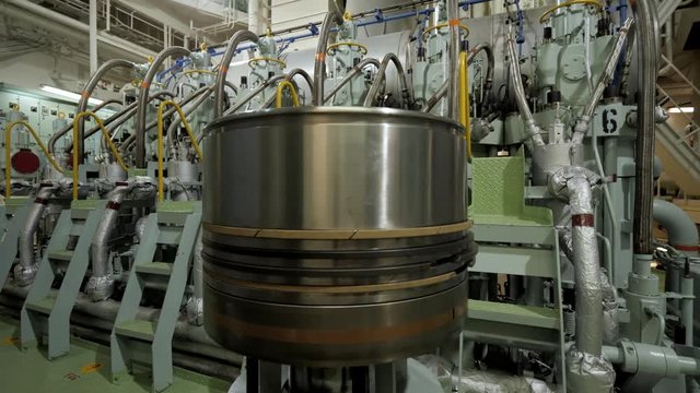 New piston near marine diesel in engine room of ship
