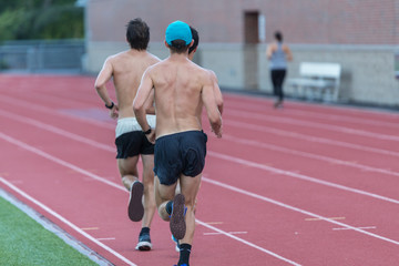 Thre men in black short are running