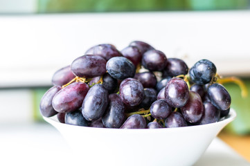 Bowl with pink grapes