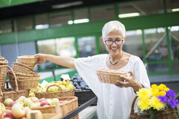 Senior woman buying  on market