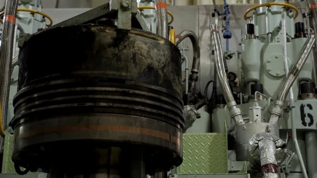 Carbon deposit on used piston near diesel engine of ship