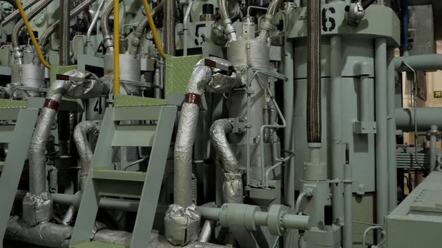 Used piston near diesel engine of vessel