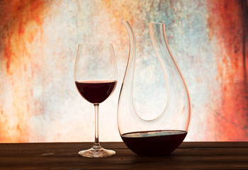Red wine in glass and decanter against beautiful background