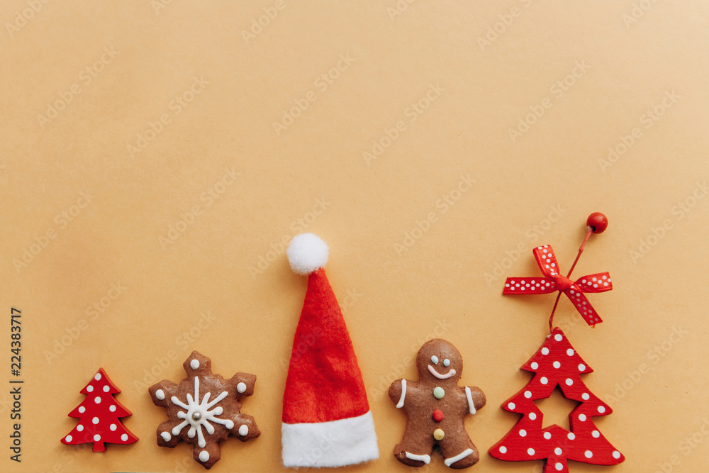 Wall mural Christmas concept. Various Christmas toys, decorations and food including gingerbread cookies on a yellow background.