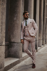 Businessman leaning on the wall and looking to the side