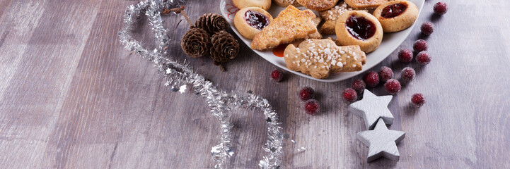 Christmas cookies with decoration on wooden table. Panorama