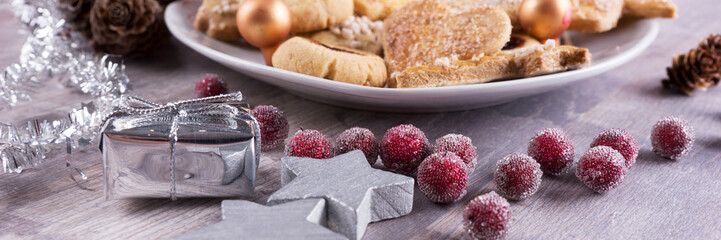 Christmas cookies with decoration on wooden table. Panorama