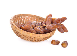 bunch of dates fruit in bamboo basket and on white background