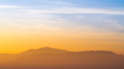 Blue and orange sunlight sky of sunrise in morning with the mountains