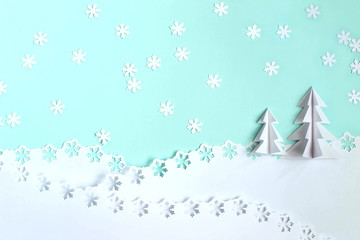 Christmas background made of paper with 3d Christmas trees and snowflakes
