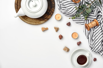 Opened diary with pen on the table near hot cup of black tea