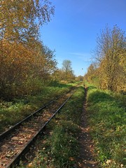 Fototapeta premium Old railway under the blue sky in autumn