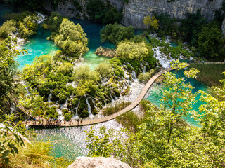 Top view of Plitvice Lakes with waterfalls with crystal clear water in surrounding forest in The...