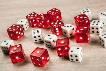 white and red dice scattered on the table