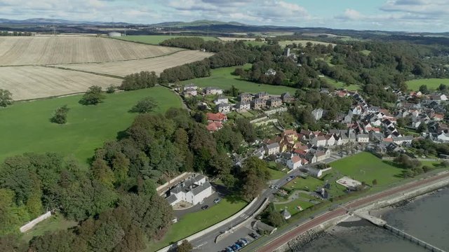 Aerial footage of the historical village of Culross on the North shore of the River Forth. White-harled houses, red-tiled roofs and cobbled streets. A location for the hit television series Outlander.