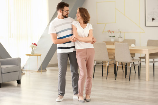 Lovely couple dancing together at home
