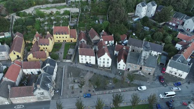 Aerial footage of the historical village of Culross on the North shore of the River Forth. White-harled houses, red-tiled roofs and cobbled streets. A location for the hit television series Outlander.