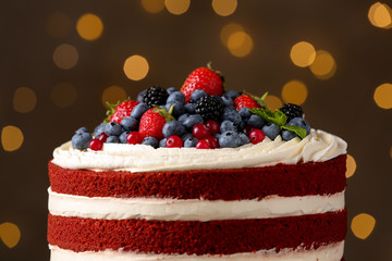 Delicious homemade red velvet cake against blurred lights