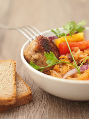 homemade stewed cabbage with salad and chop