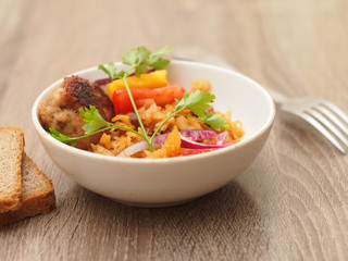 homemade stewed cabbage with salad and chop