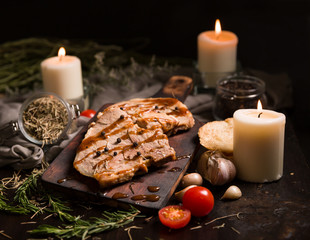 Grilled T-bone steak on cutting board