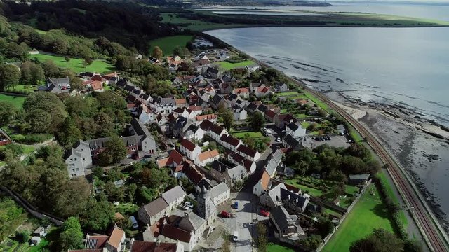 Aerial footage of the historical village of Culross on the North shore of the River Forth. White-harled houses, red-tiled roofs and cobbled streets. A location for the hit television series Outlander.