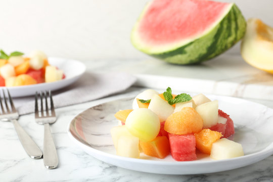 Salad with watermelon and melon on marble table