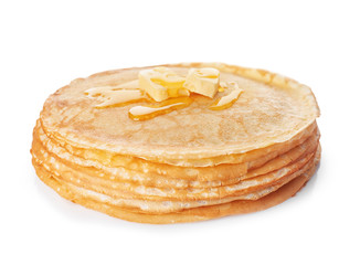 Stack of tasty thin pancakes with maple syrup and butter on white background