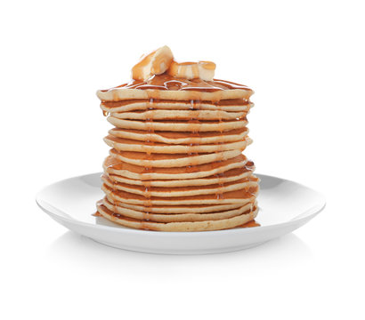 Plate with stack of tasty pancakes and maple syrup on white background