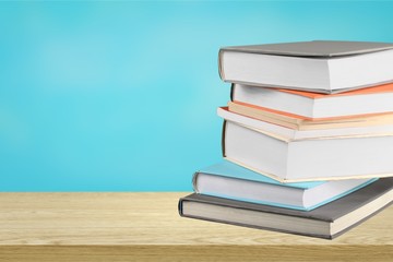 Stack of colorful books on blurred background
